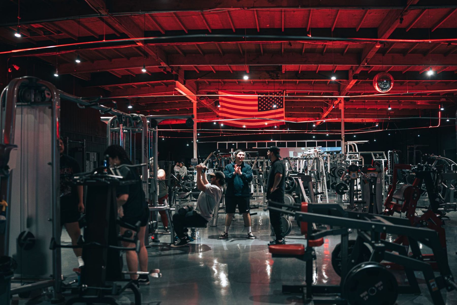 People training in the red-lit main hall
